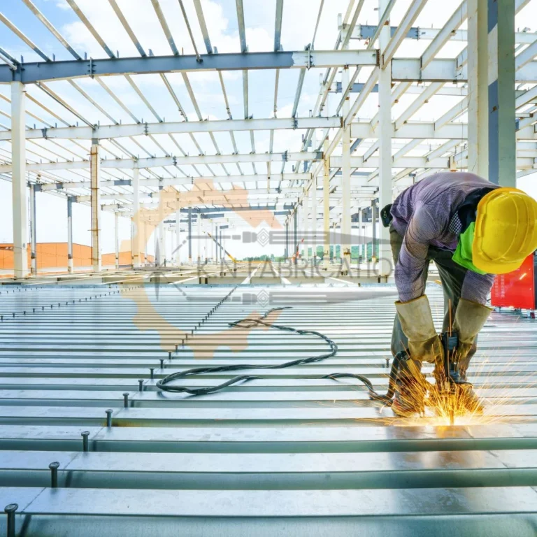 Worker welding metal beams indoors